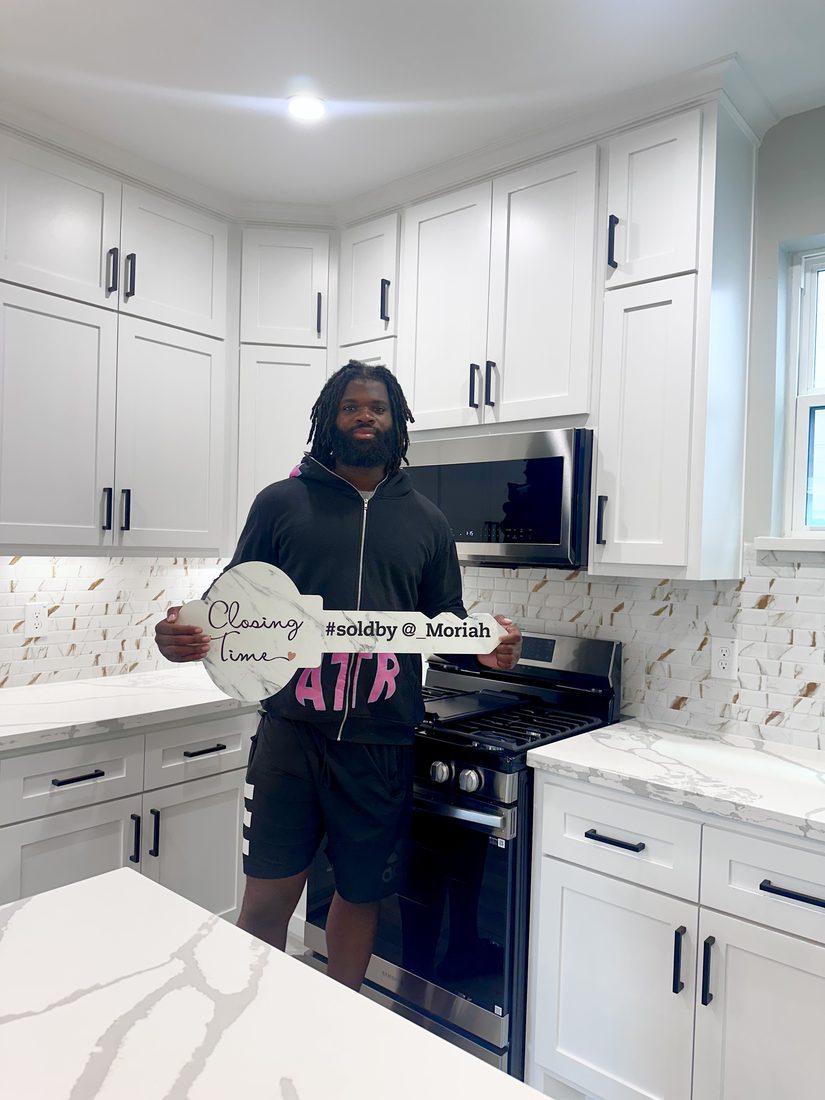 Client celebrating his new home purchase in his new kitchen